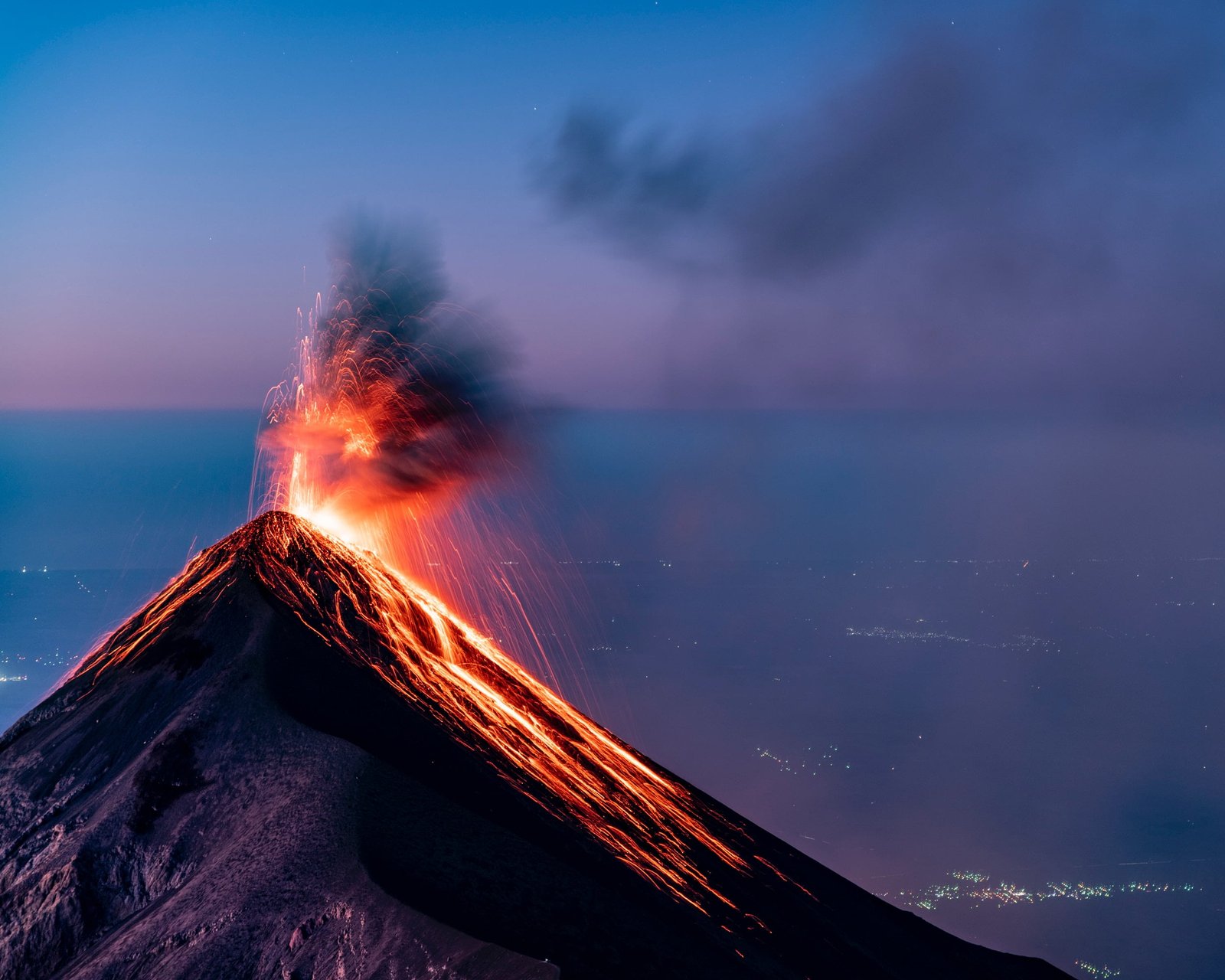 An active volcano with lava in the night sky