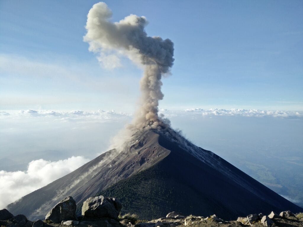 A large volcano sending smoke into the sky