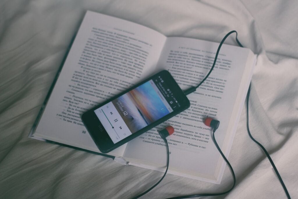 Headphones and a book for listening to music to induce a lucid dream