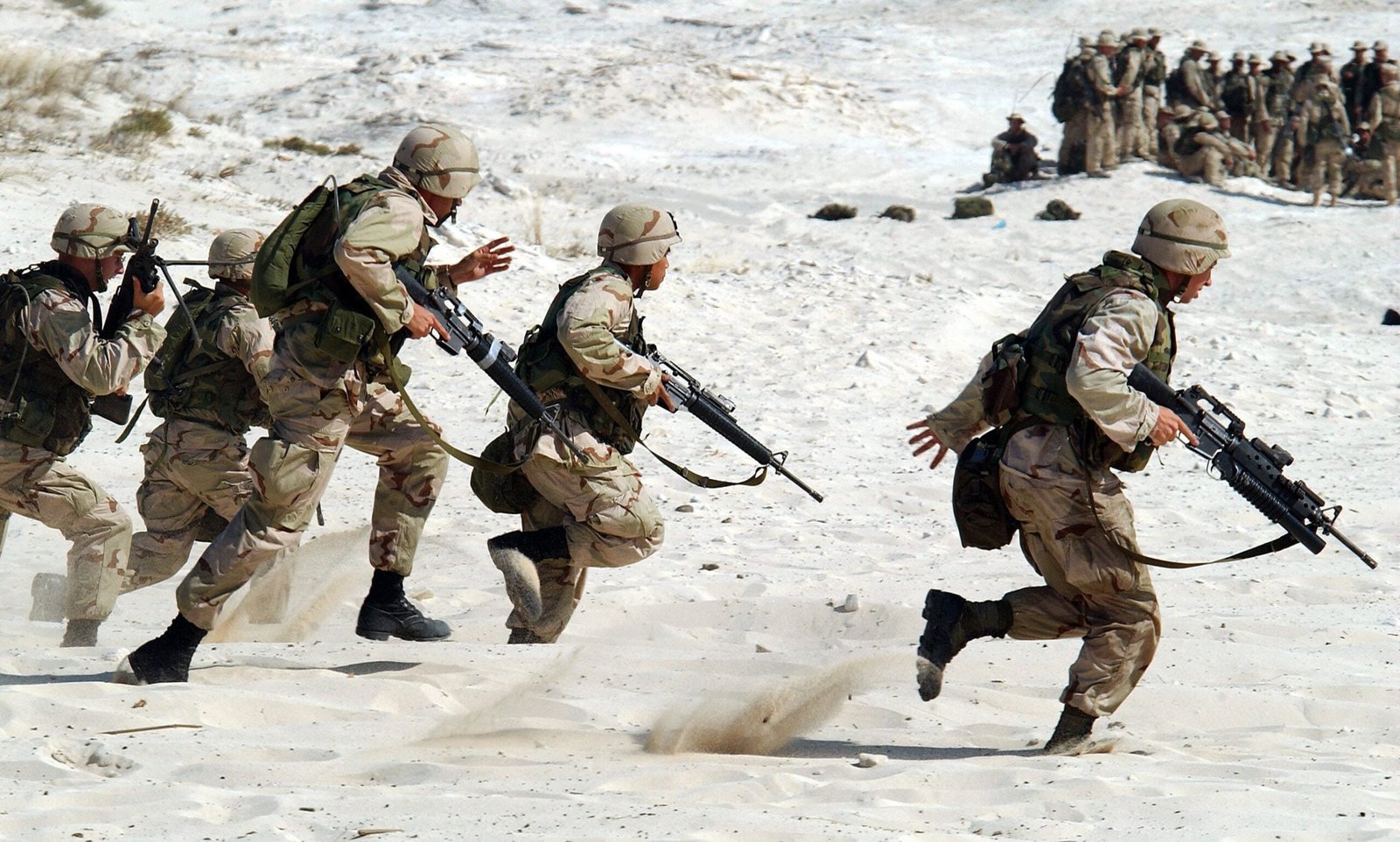 Soldiers running on sand, training for war